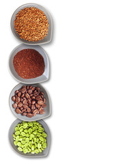 Bowls with green, roasted coffee beans, ground and instant