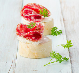 Baguette with salami and cream cheese with herbs.