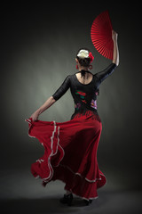 young woman dancing flamenco with fan on black - obrazy, fototapety, plakaty