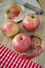 apples and knife on wooden table