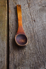 Old wooden spoon on boards.