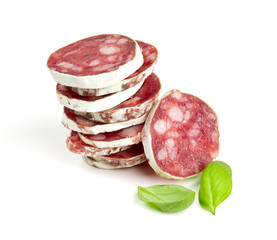 stacked sliced salami isolated on white