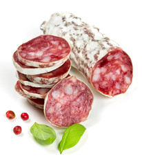 stacked sliced salami isolated on white