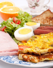 omelette with ham, bacon and vegetables close up