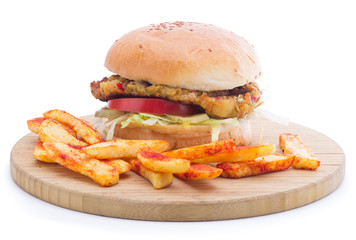Vegetarian burger on wooden plate with french fries