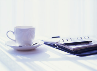 notebook and coffee cup