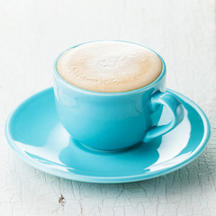 Cappuccino coffee in blue coffee cup