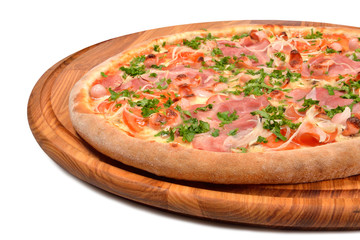 pizza with ham tomato and onion on a wooden platter