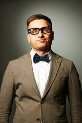 Confident nerd in eyeglasses and bow tie