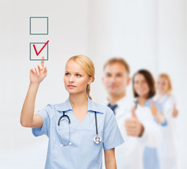 smiling doctor or nurse pointing to checkmark