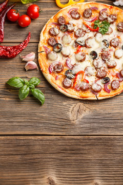 Pizza on old wooden board