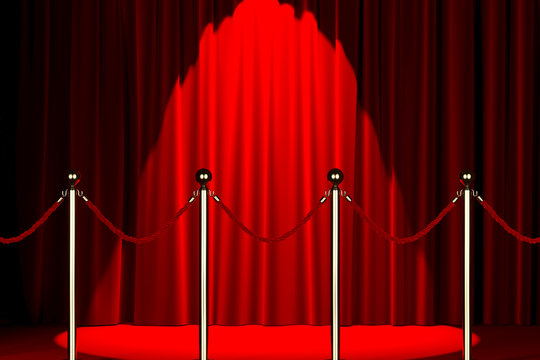Rope barrier with red carpet and spotlight