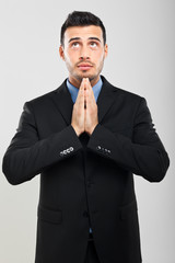 Businessman praying in supplication