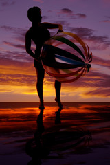 silhouette of woman with big beach ball