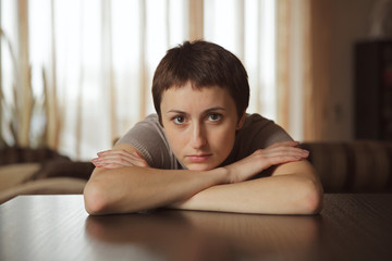 Young woman sitting and looking to us