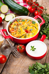 Vegetable casserole in a red pot