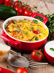 Vegetable casserole in a red pot