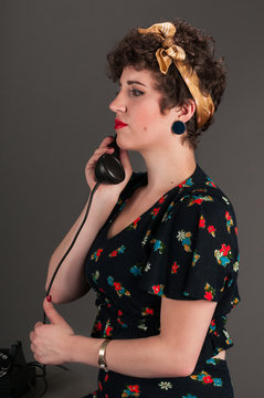 Pinup Girl in Flowered Outfit on Phone - Serious