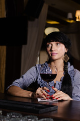 Sad thoughtful woman drinking at the pub