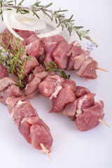 fresh pork skewers with vegetables, onions and rosemary