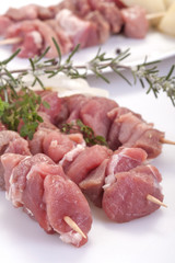 fresh pork skewers with vegetables, onions and rosemary