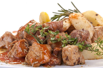 fresh roast pork in sauce with rosemary and potatoes