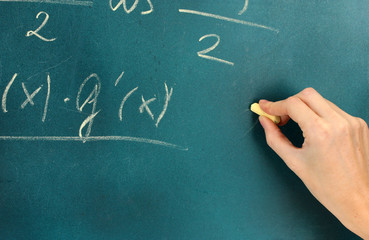 Math formula written on blackboard with chalk.