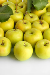 juicy apples with green leaves, isolated on white