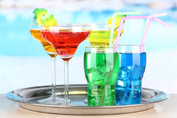 Different  colorful cocktails on bright background