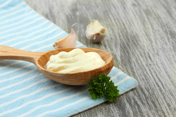 Fototapeta na wymiar Sour cream in spoon on table close-up