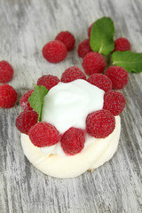 Tasty meringue cake with berries on wooden table