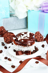 Tasty cupcakes with gifts close up