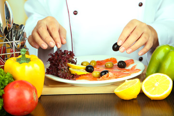 Cook hands decorating dish