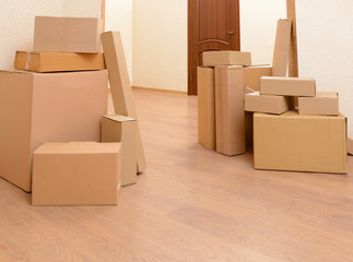 Empty room with stack of cartons: moving house concept