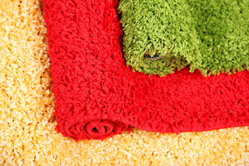Many carpets of different colors close-up