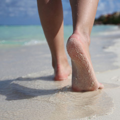 Female Feet on Tropical Sand Beach. Legs Walking.