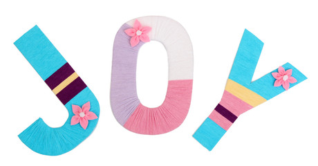 Word Joy created with brightly colored knitting yard isolated