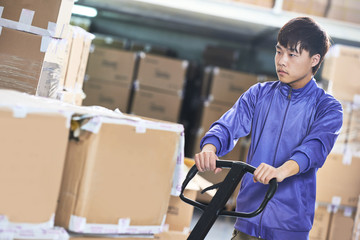 chinese warehouse worker with forklift stacker