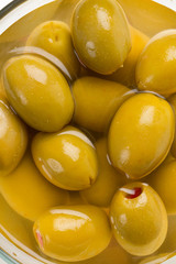 Green olives stuffed with red paprika