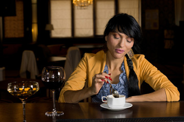 Elegant woman drinking coffee at the bar
