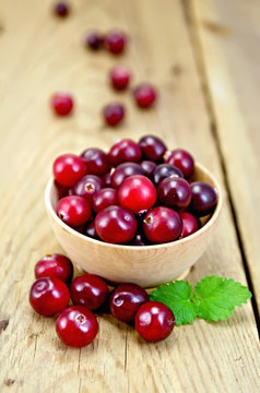 Cranberries in a wooden bowl on the board