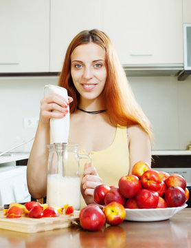   woman making beverages with  blender from nectarines