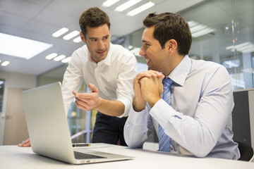 Fototapeta premium Two handsome businessmen working together on a project,office