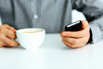 Closeup image of a male hand typing on smartphone