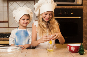 Children cooking Christmas cakes