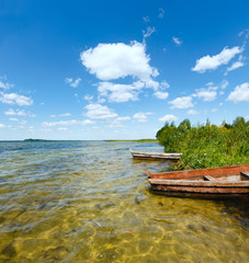 Obraz premium Summer lake view with wooden boats.