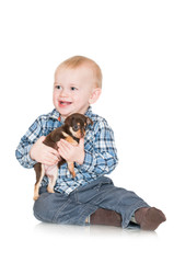 Obraz premium adorable little boy holding a puppy