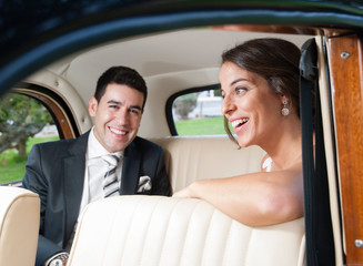 Bride and groom inside a classic car