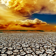 dramatic color clouds over drought earth