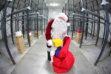 Santa Claus preparing for Christmas in storehouse